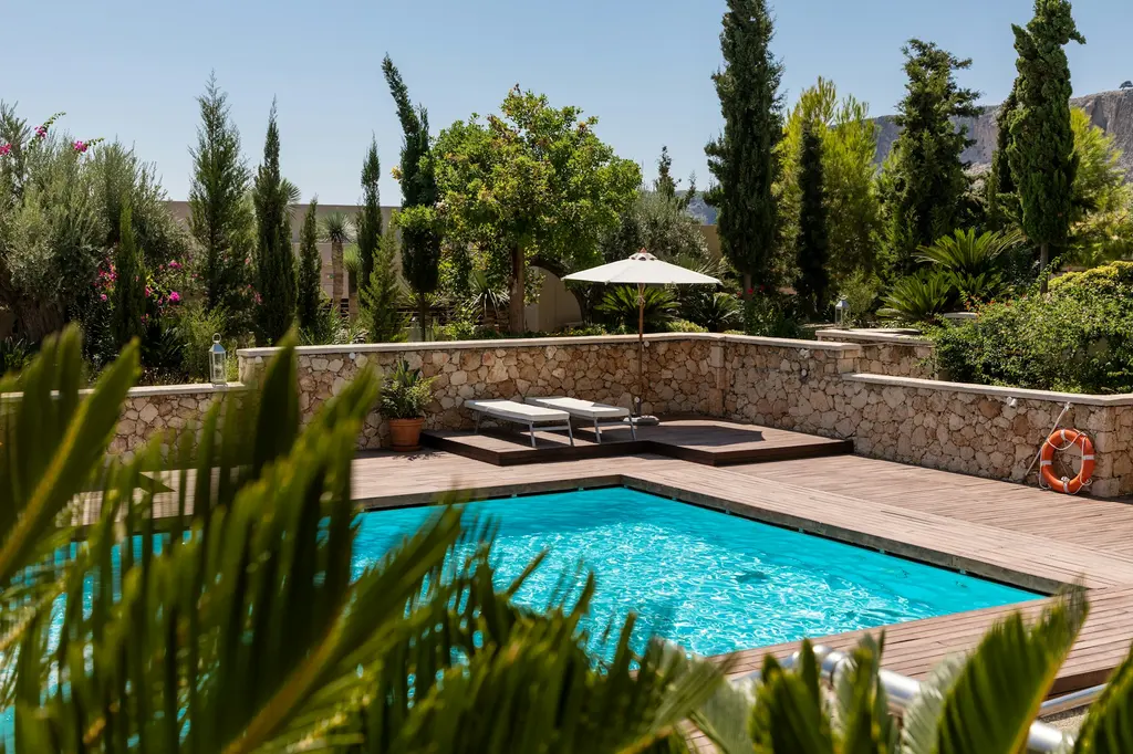 Manicured Mediterranean garden with cypress trees and pool