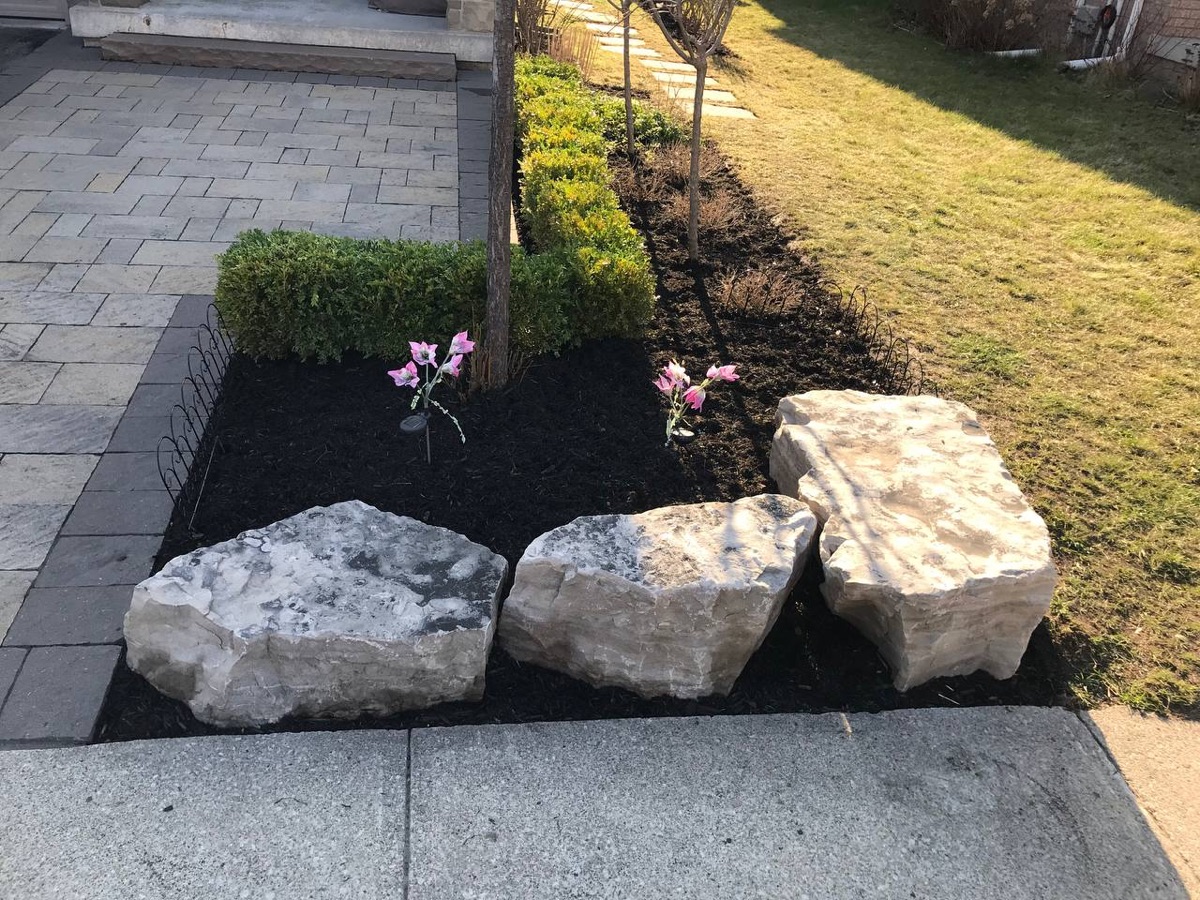 Armour stone accent bed with mulch and shrubs