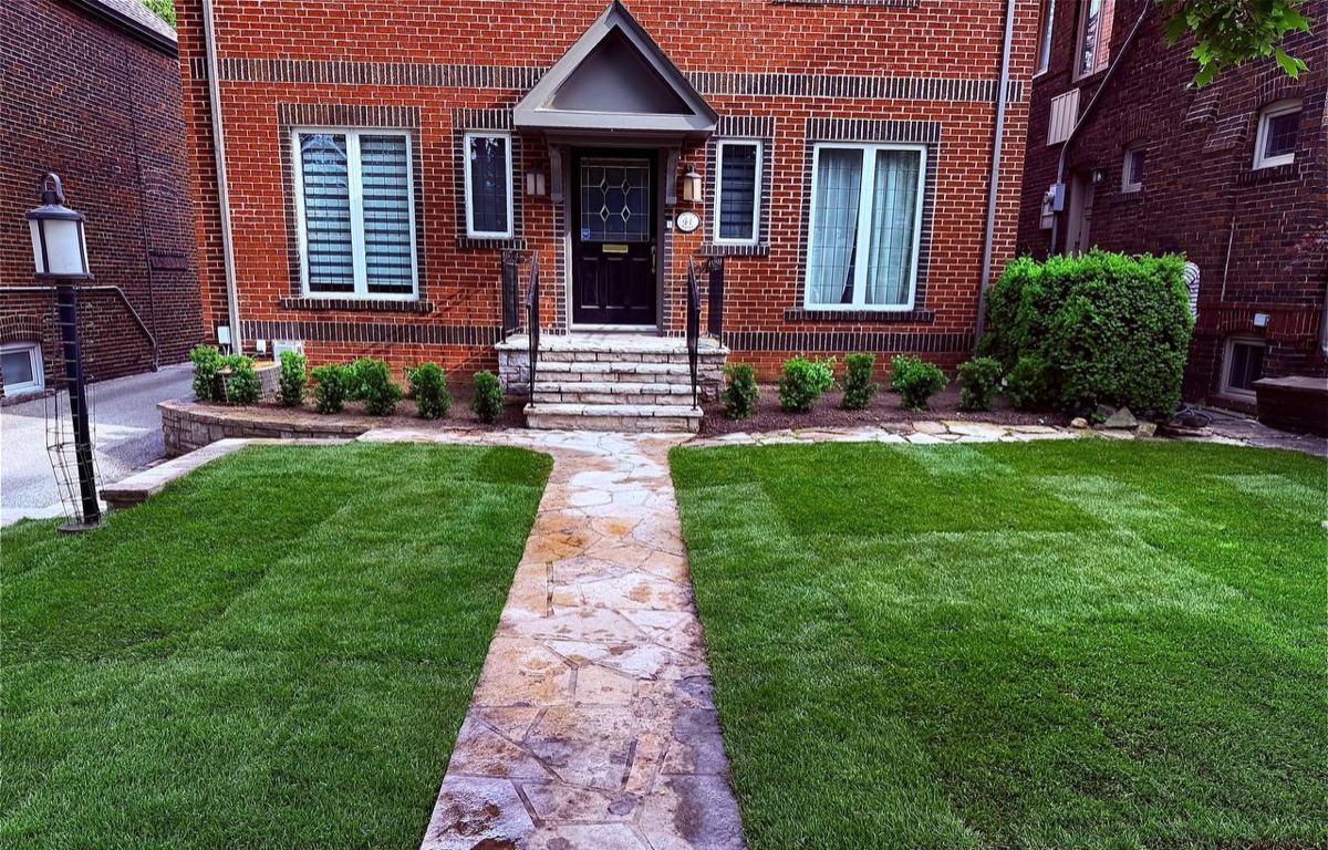 Flagstone walkway with fresh sod lawn