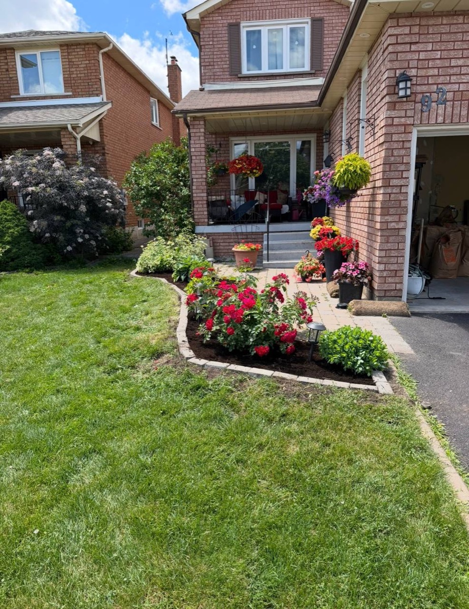 Front garden with flowering beds and paver border